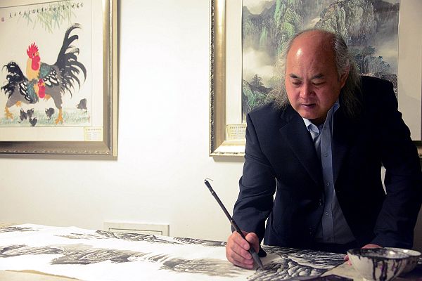 2014年4月13日，国礼画家吴进良在”吴进良美术馆“画室作画。